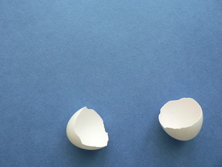 Easter egg. Egg shells on a blue background with copy space for your text. Banner minimalistic decoration concept. The shell of a broken egg, the eggshell is fragile and empty.