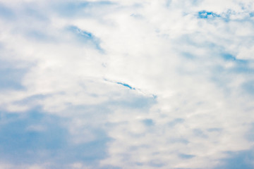 The sky is bright blue but overshadowed by white clouds for the background.