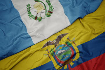 waving colorful flag of ecuador and national flag of guatemala.