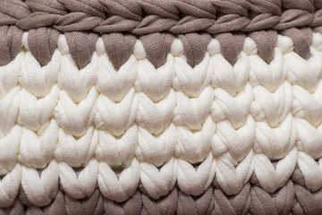 Seamless knitted background. Knitted texture from knitted thread. Texture of a carpet or basket. Handmade.