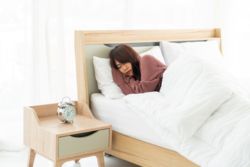 Asian woman sleeping on bed in morning