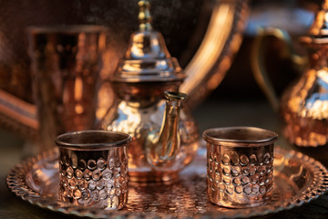 Moroccan teapot with tea cups made of copper.