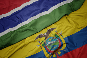 waving colorful flag of ecuador and national flag of gambia.