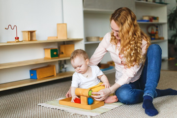 Mom and baby are playing in the Montessori center