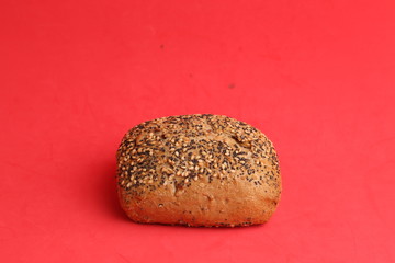 delicious bread rolls on colored background