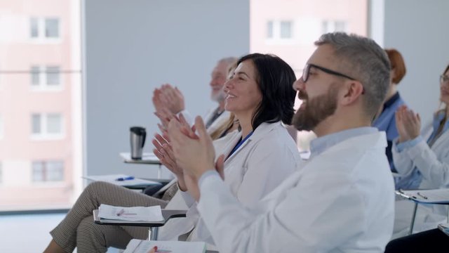 Group of doctors listening to presentation on medical conference.