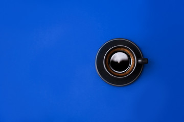 Top view of Cup of coffee on blue background