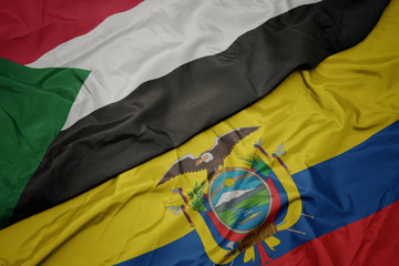 waving colorful flag of ecuador and national flag of sudan.