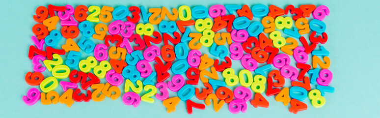 Top view of colorful numbers on blue background, panoramic shot