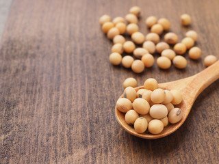 Fototapeta na wymiar Soybeans in wooden spoon on table, Protein plant health food.