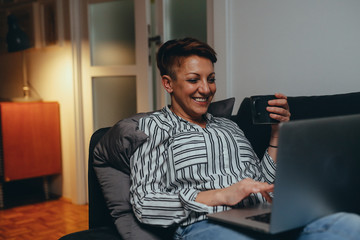 mother working from home and baby sitting her baby boy