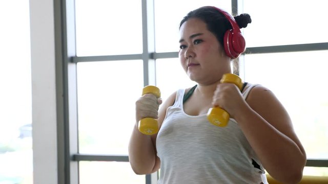 Overweight Young Woman In Sportswear Exercising To Lose Weight At Home