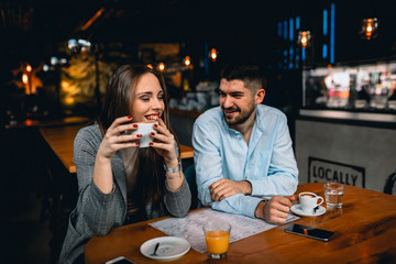 friends sitting in cafe drinking coffee and talking