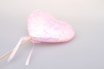 Pink heart on a white background. A close-up.