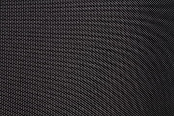 Black dense fabric, background. Close-up.