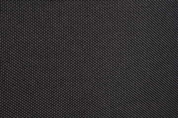Black dense fabric, background. Close-up.