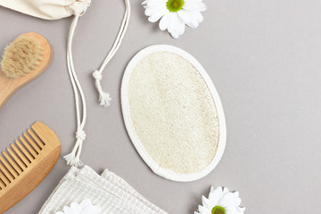 White chamomile, accessories for personal hygiene. Zero waste composition on gray background.