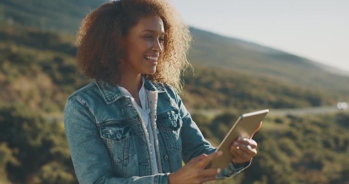 Young attractive african american woman taking photos with her smart tablet outdoors, happy tourist taking photos on her vacation