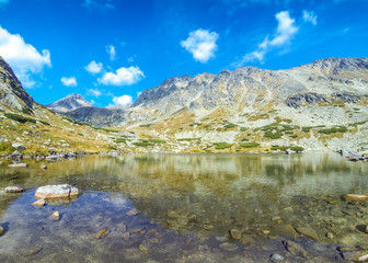 Hiking in High Tatras Mountains, Slovakia. Lake over Skok waterfall (Slovak: Pleso nad Skokom) (1801m). Mounts Satan (2421m), Predna Basta (2374m), Mala Basta (2288m) on the background © katatonia