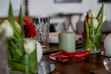 Fototapeta na wymiar horizontal closeup photo of a candle surrounded by beautiful bouquets
