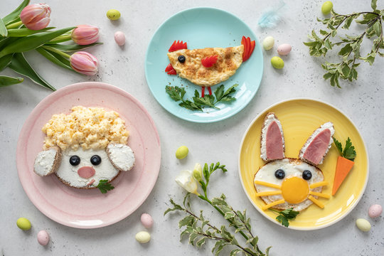 Naklejki Colorful breakfast meal for kids. Funny Easter food art, top view.