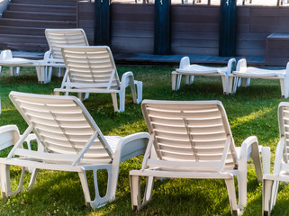 Sun loungers and umbrellas on green grass