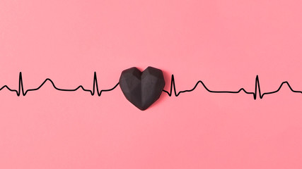 Echocardiogram of love, cardiac markers with plastic black heart.