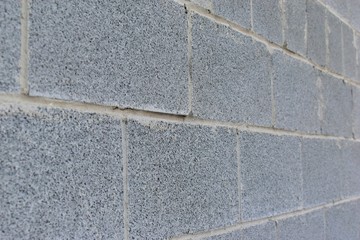 Fototapeta premium The gray wall is made of brick and cinder block
