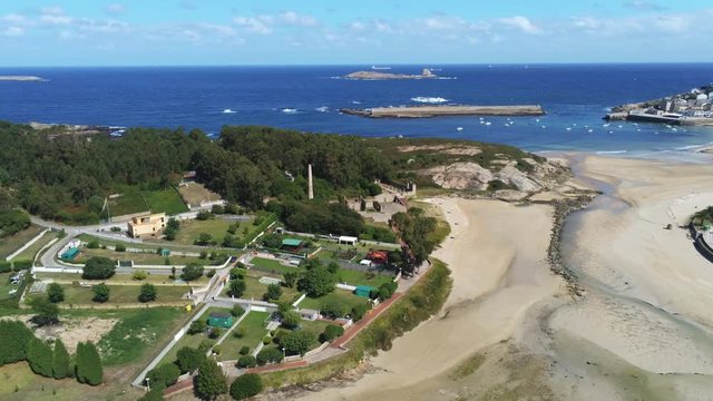 Aerial orbit shot over beach and fileds of San Ciprian, coastal village of Lugo, Spain