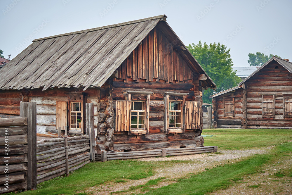 Wall mural Old rural wooden house in a russian village