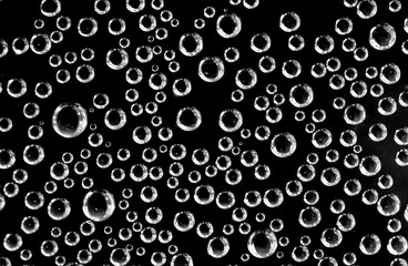 Air balls in water on a black background