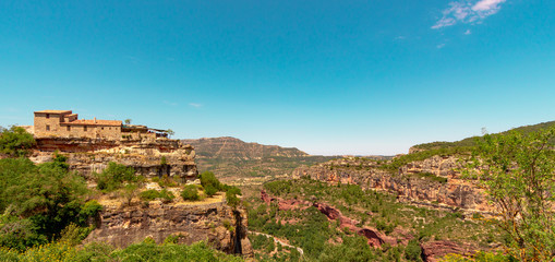 Landscape of the Siurana village of Tarragona with rocky mountains and clouds in the sky.