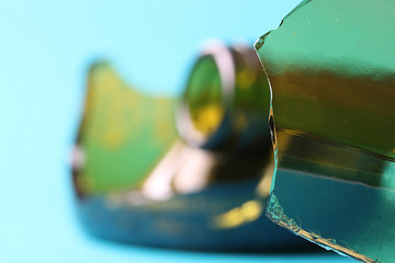 Shards of green bottle on a turquoise background