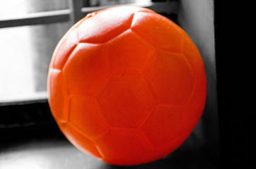 Orange ball on a black and white background