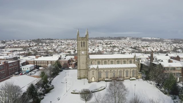 Aerial view of St Jame's church covered in snow in the midlands, Christian, Roman catholic religious orthodox building in a mainly muslim area of Stoke on Trent in Staffordshire, City of Culture