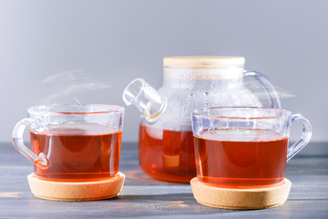  Tea ceremony. Glass teapot and two cup with hot tea.