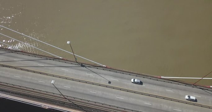 Aerial shot of cars and trucks passing over the bridge