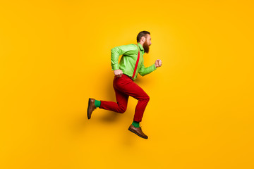Fototapeta na wymiar I need run faster. Full length profile side photo of focused irish gentleman jump hurry want buy shopping center discount wear good look outfit isolated over yellow color background