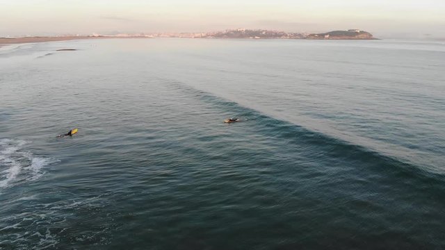 Novice surfer in water at sunrise and beautiful scenery