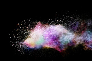Abstract powder splatted background. Colorful powder explosion on black background. Colored cloud....