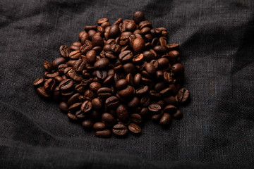 Composition with a coffee beans on a linen napkin for background
