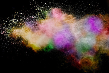 Abstract powder splatted background. Colorful powder explosion on black background. Colored cloud....