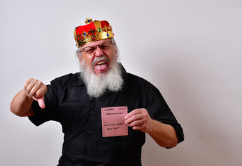 A really fierce and sadistic employer fires a hapless employee. . .Mature jerk with a golden crown and black guayabera shirt and long white beard..