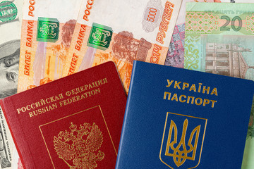 Russian and ukrainian passport on russian and ukrainian money banknotes