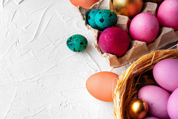 Brightly painted Easter eggs composition on white embossed background