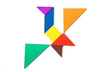 Color wood tangram puzzle in flying bird shape on white background