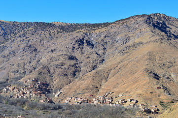 Berber villages and houses made out of clay at the hills and mountains of High Atlas 