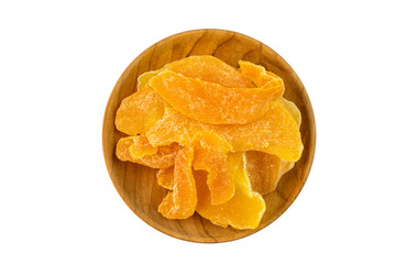 Top view of pile dehydrated mango in a wooden plate on white background with clipping path.