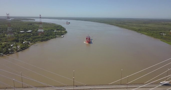 the cargo ship is sailing along the parn river. between the province of buenos aires and between rivers.