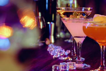 Two beautiful cocktails served on a wooden bar counter